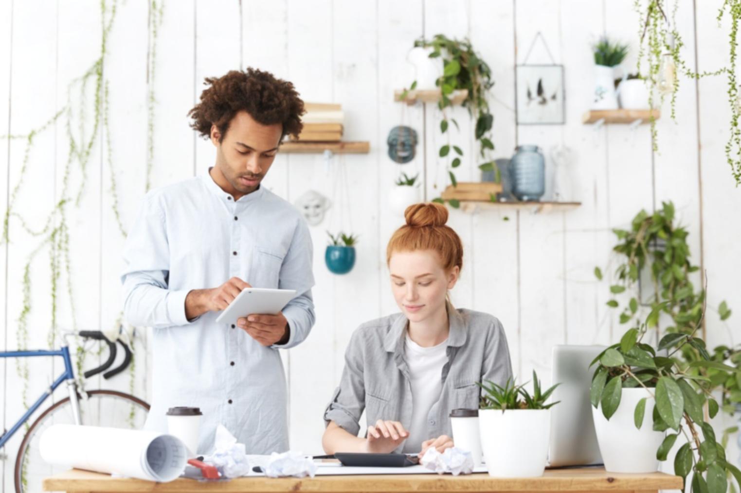 Professional workspace with financial charts and modeling software on multiple screens